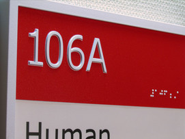 Close-up of ADA lettering economical ada signs Braille lettering